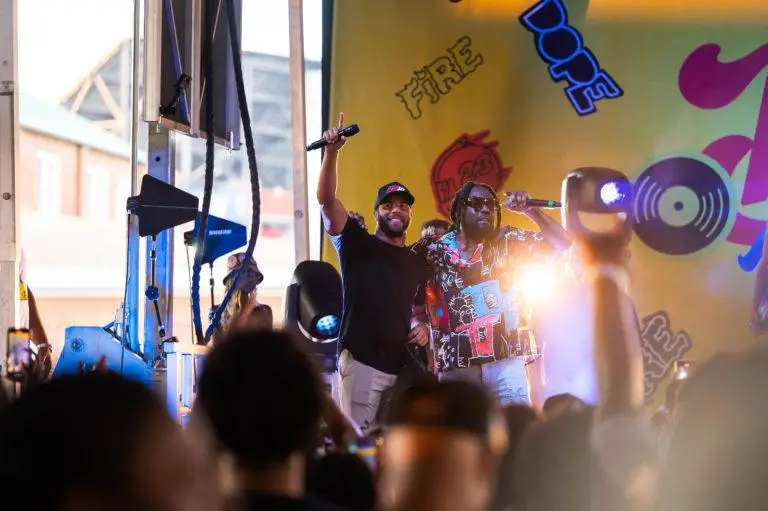 Performers on the Bubba’s Block Party stage with vinyl record set decor and stage lighting