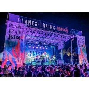 Stageline SL100 mobile stage at a night festival with banners across the header and both side wings