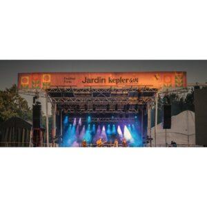 Stageline SL225 mobile stage with a full-width festival banner mounted across the top of the roof