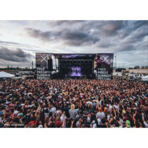 Stageline SL320 mobile stage with large festival banners mounted on both side wings above a crowd