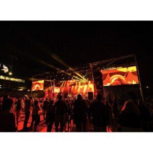 Stageline SL320 mobile stage at a nighttime concert with LED video walls flanking each side of the stage